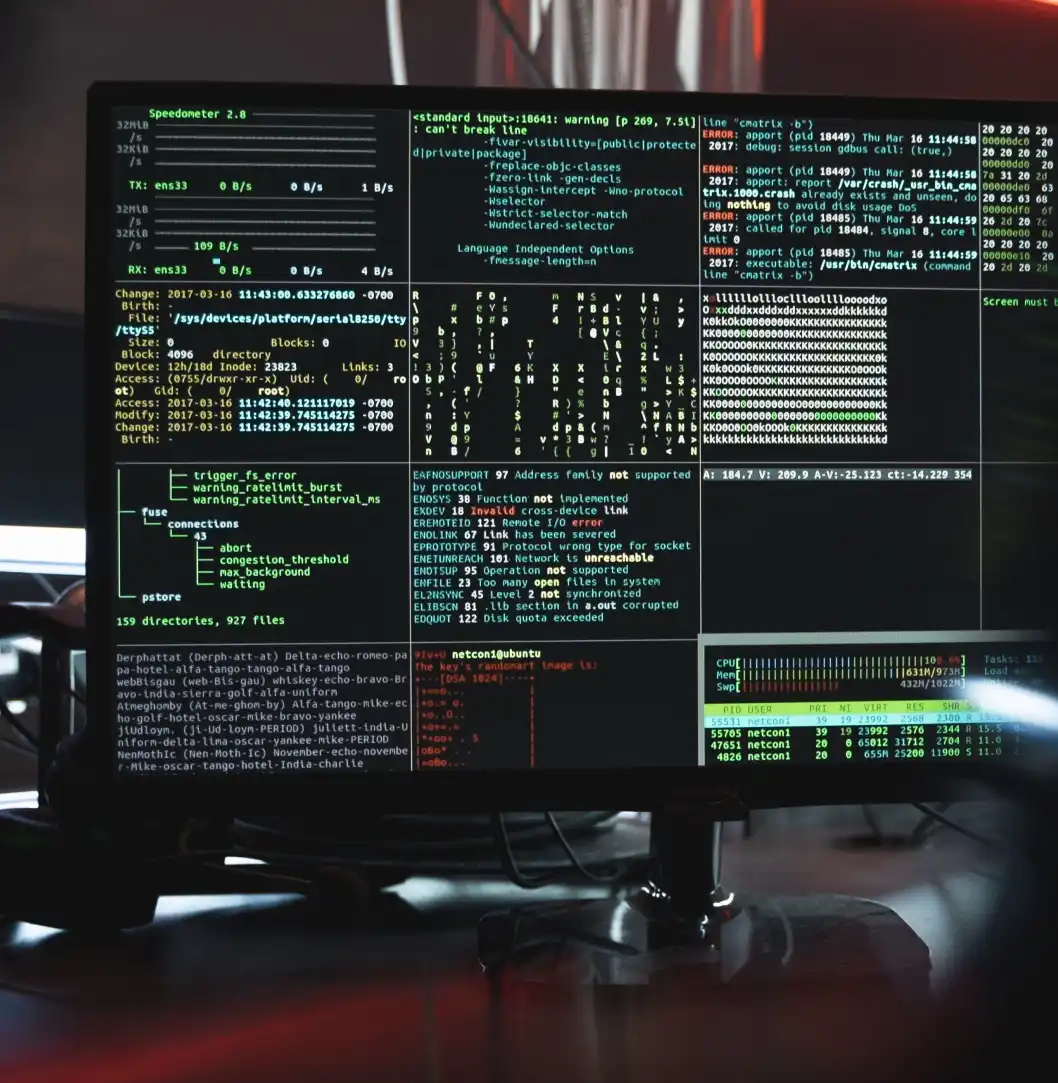 A close-up of a computer screen displaying multiple terminal windows filled with code and system information, including network traffic data, errors, and processes.