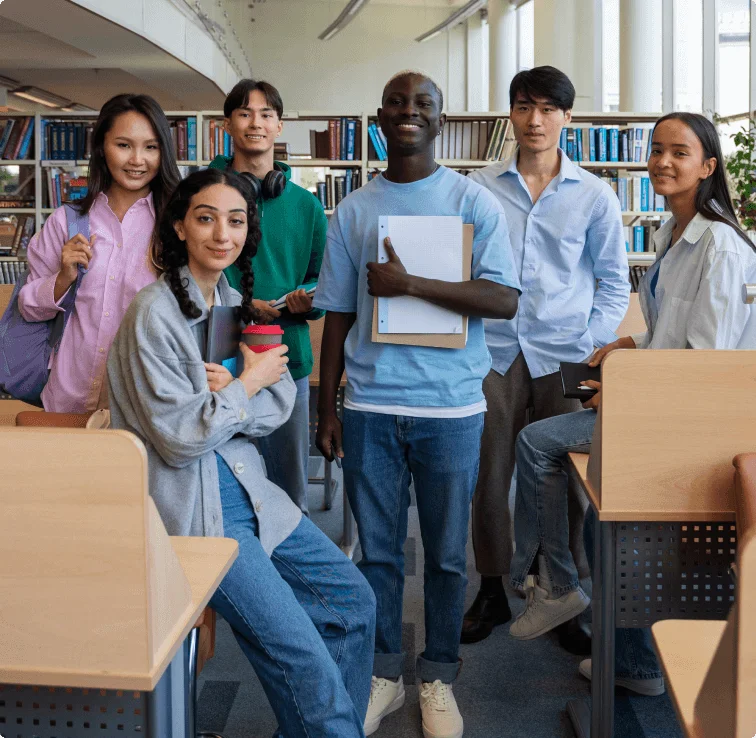 Students standing in university library.
